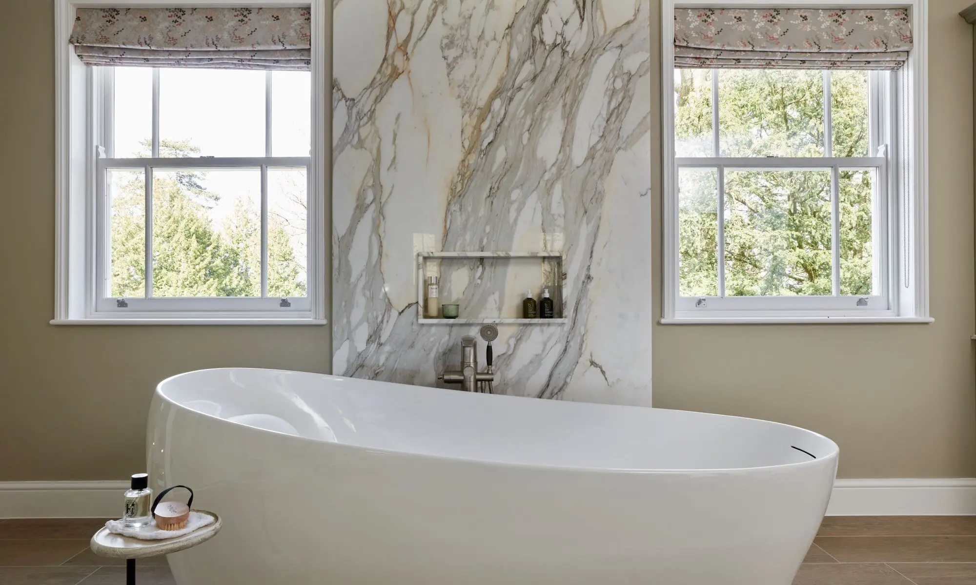 A bathroom with a large tub and two windows.