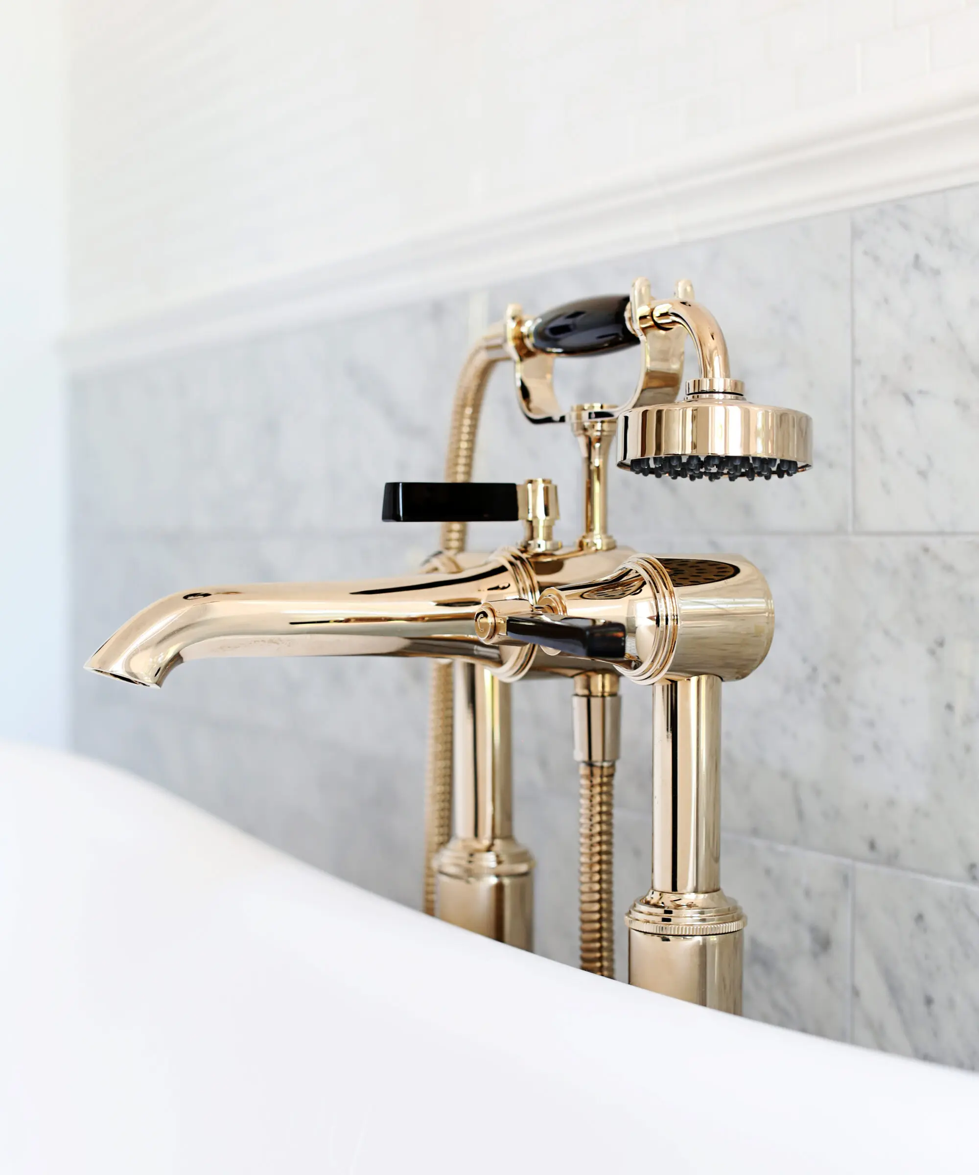 Antique Gold luxury Art Deco taps beside a bathtub