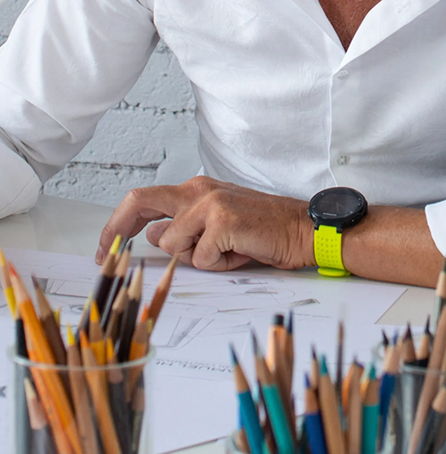 Product designer at a desk sketching bathroom fixture designs