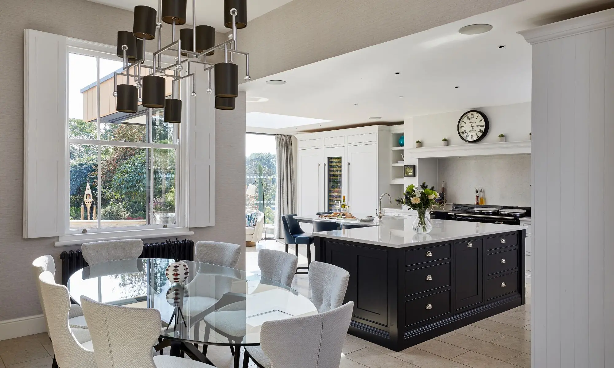 A kitchen with a dining table and chairs.