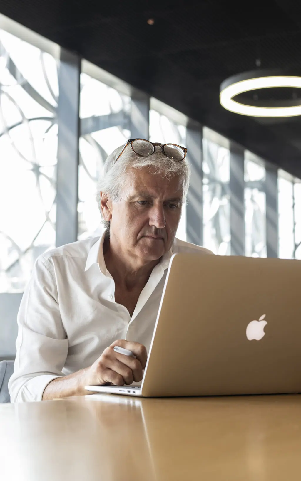 A Samuel Heath product designer researches design inspiration on his laptop.