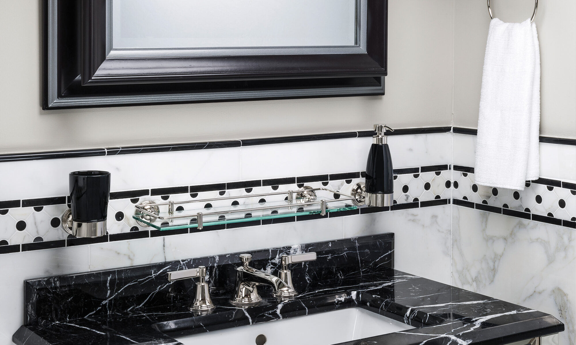 Luxury Art Deco taps mounted on a black marble basin