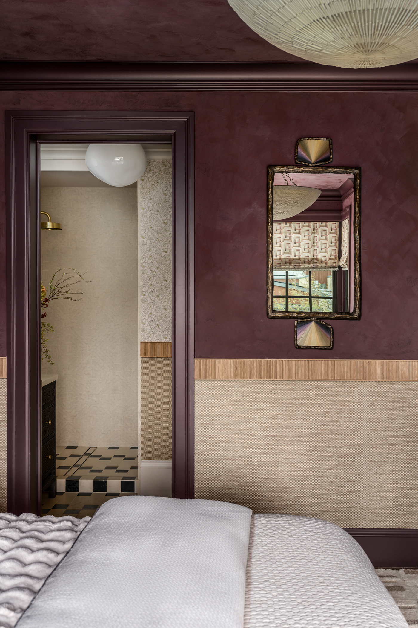 Side of bed view in The Global Nest bedroom facing ensuite bathroom doorway