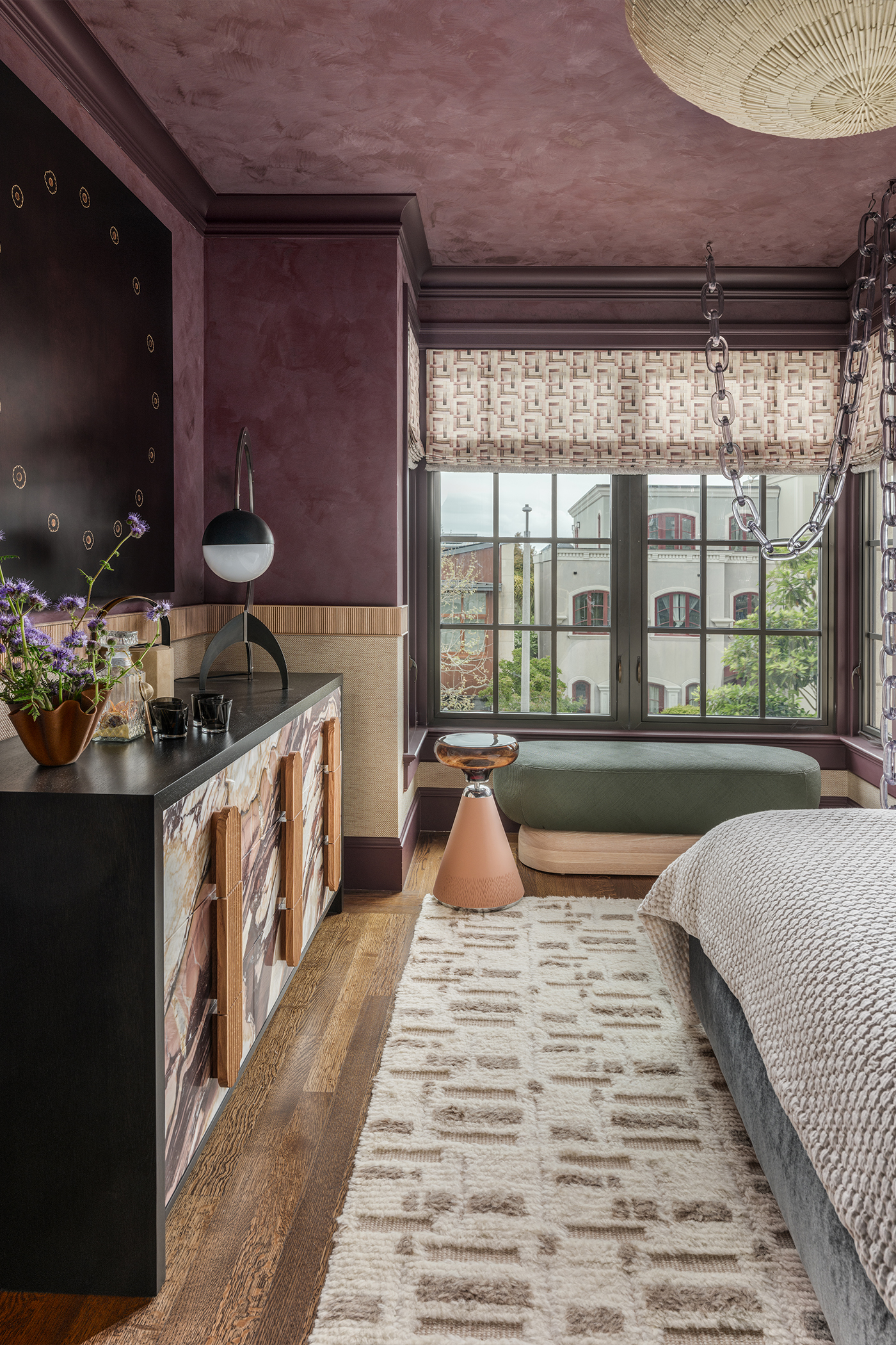 End of bed view in The Global Nest bedroom facing a large window
