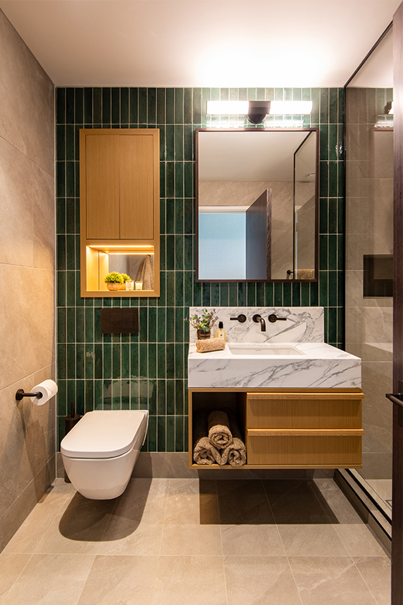 Older son's ensuite with deep green tiled wall and Landmark Pure basin tap by Samuel Heath