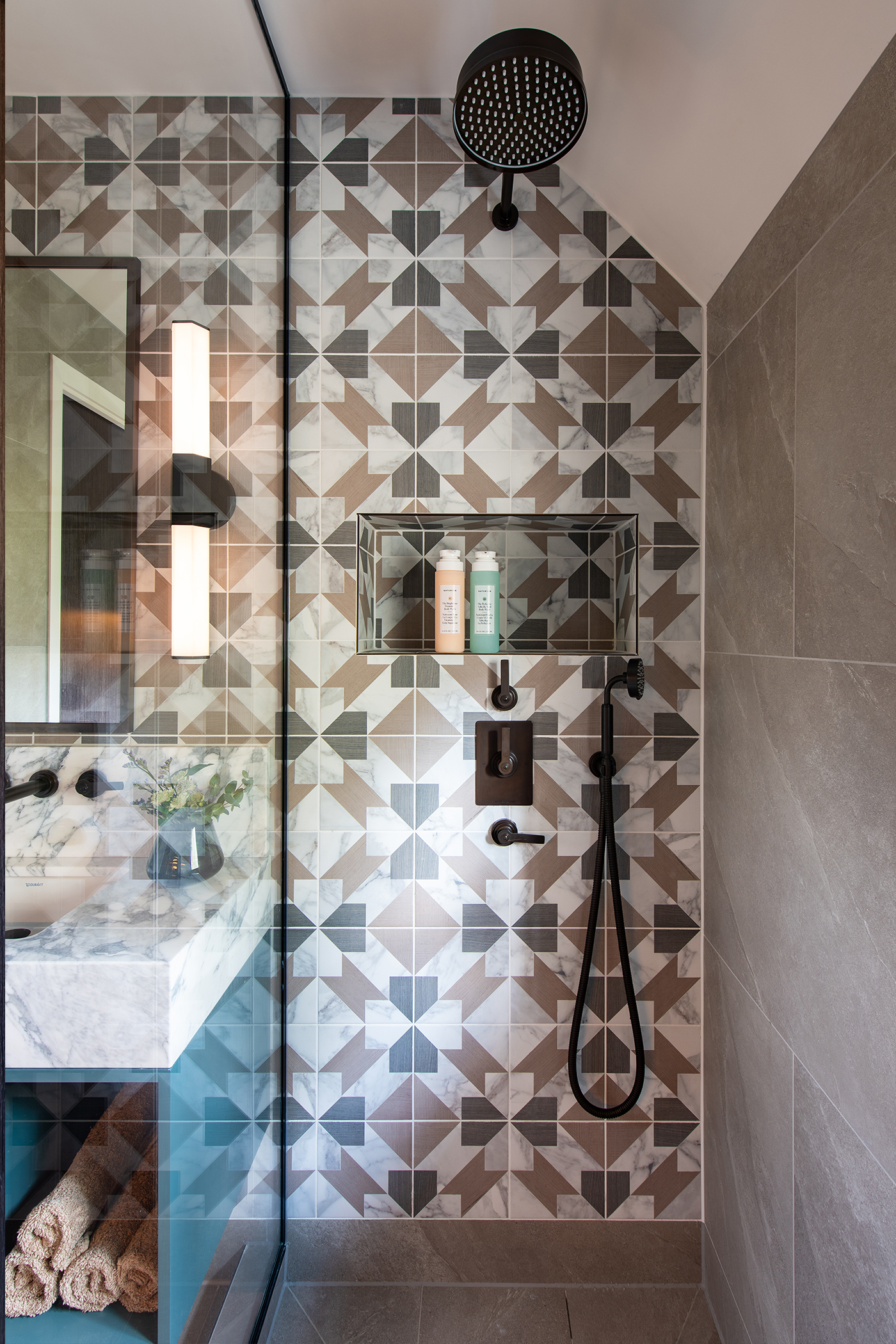 Youngest son's ensuite with geometric tile shower and Landmark Pure concealed shower set by Samuel Heath