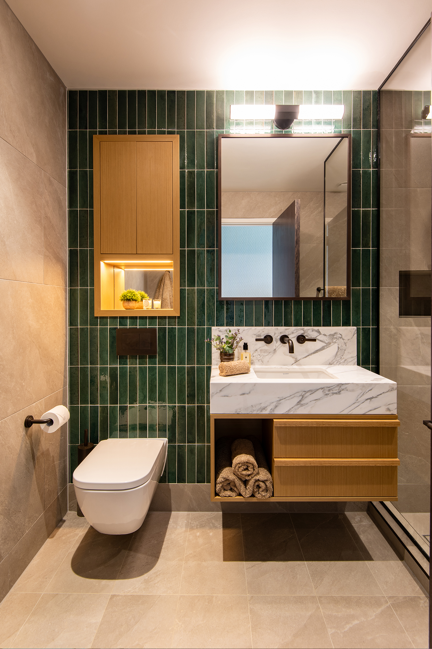 Older son's ensuite with deep green tiled wall and Landmark Pure basin tap by Samuel Heath