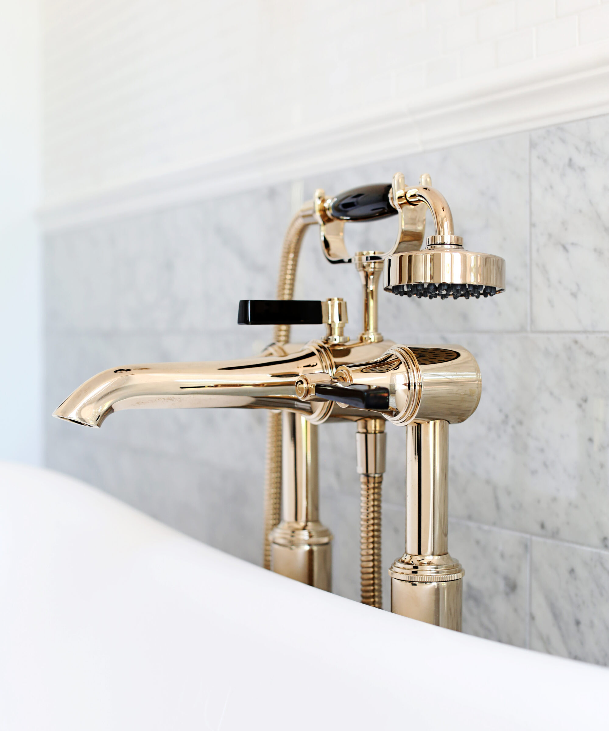 Antique Gold luxury Art Deco taps beside a bathtub