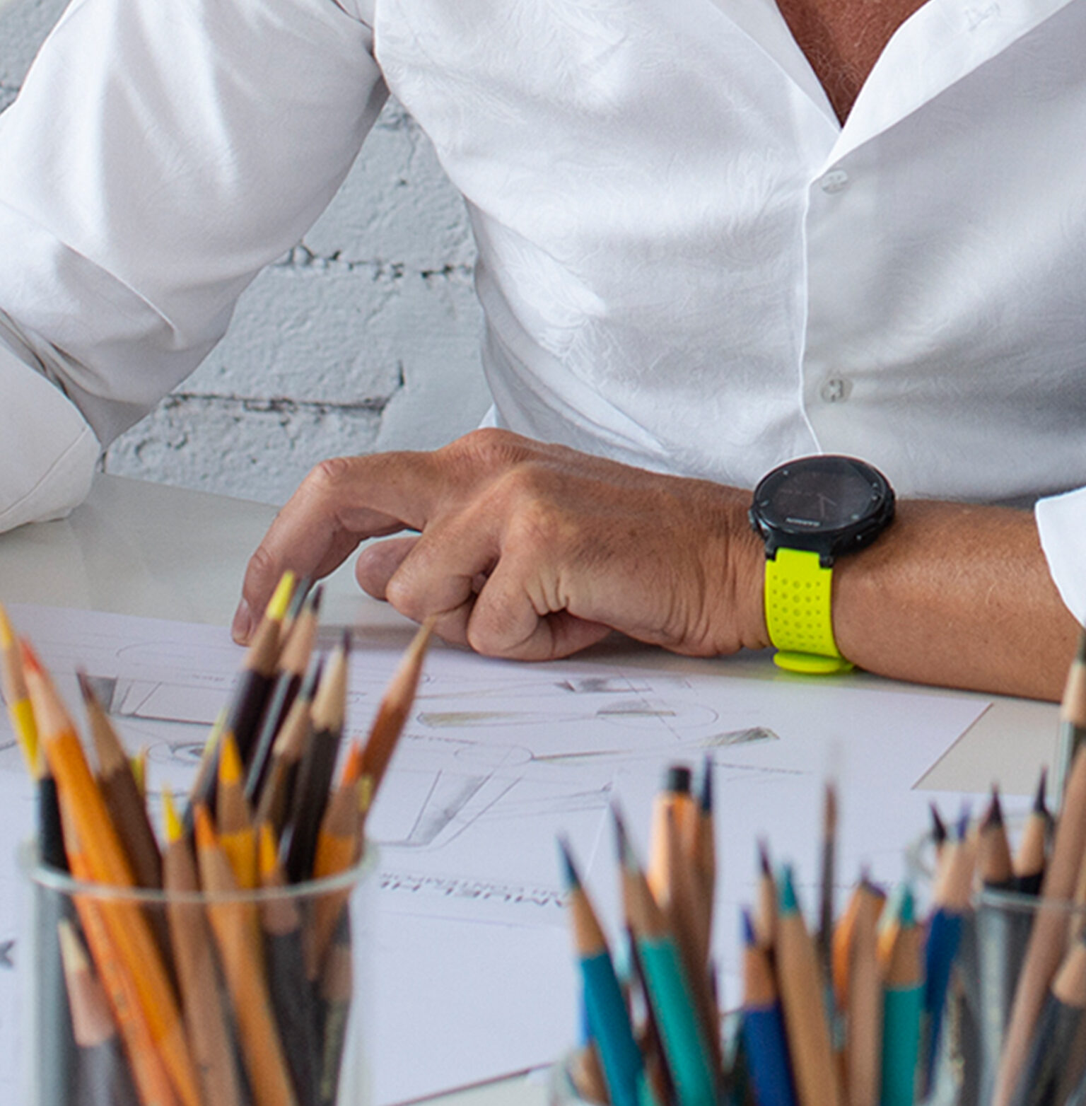 Product designer at a desk sketching bathroom fixture designs