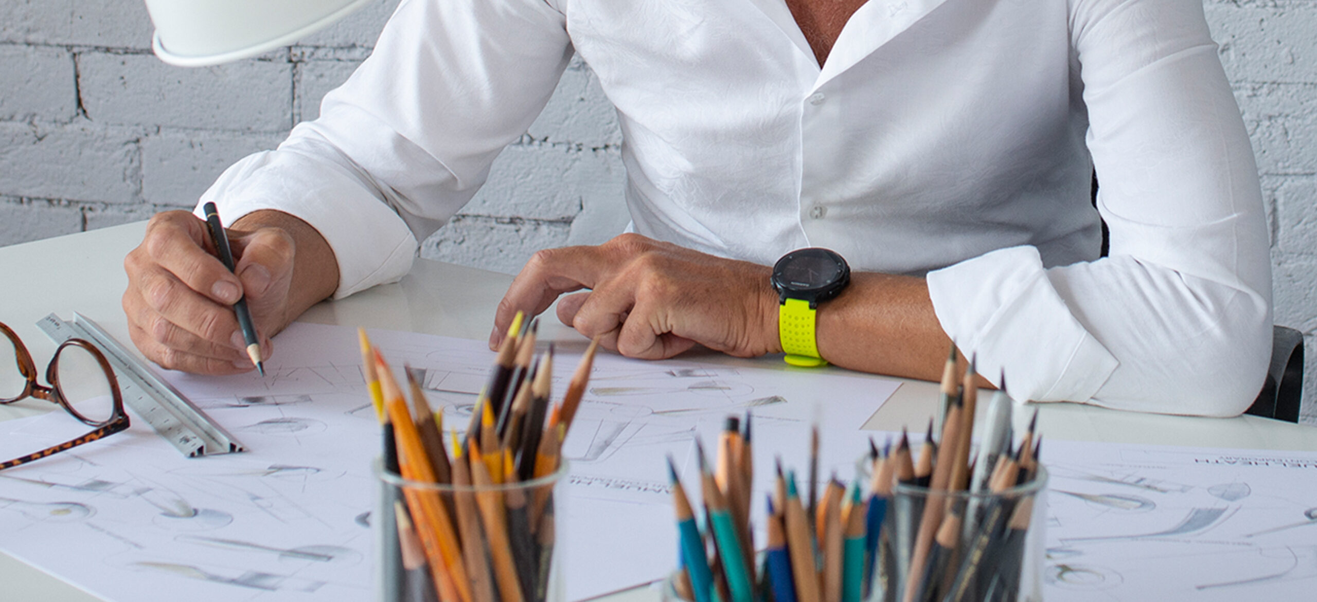 Product designer at a desk sketching bathroom fixture designs