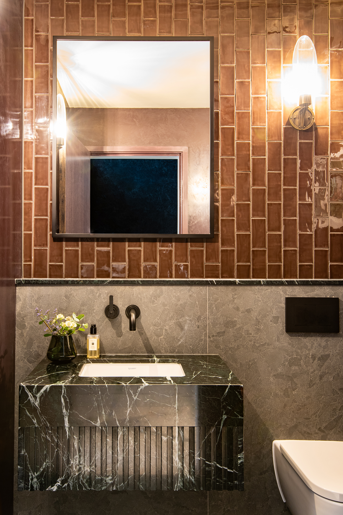 powder room with brown tiles black stone vanity and LMK pure basin mixer by samuel heath