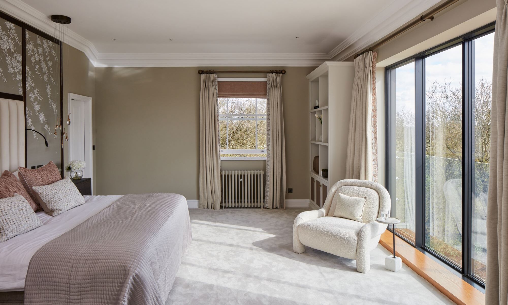 A bedroom with a bed and a chair.